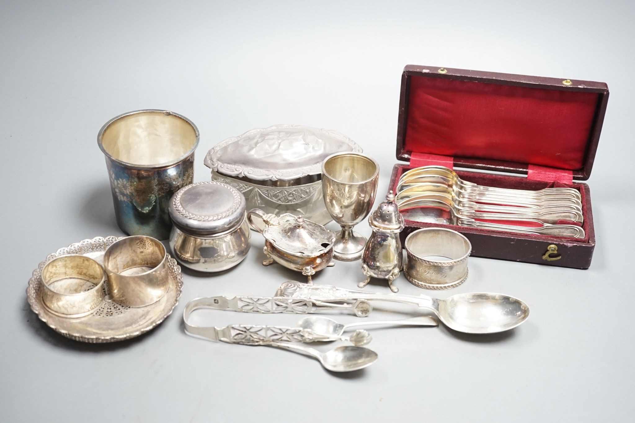 Sundry small silver, white metal and plated items, including a George III silver caddy spoon, French white metal beaker, napkin rings, condiment, tea strainer toilet jar, etc, weighable silver, 24oz.